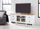 Bay Furniture Gallery - Ashley Furniture - Ashbryn 74" TV Stand - 74" / White/Natural - W844-68